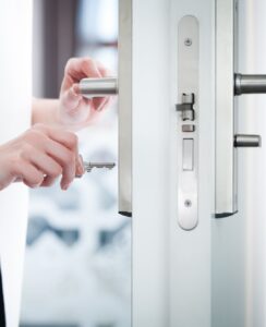 Locking or unlocking door with key in hand