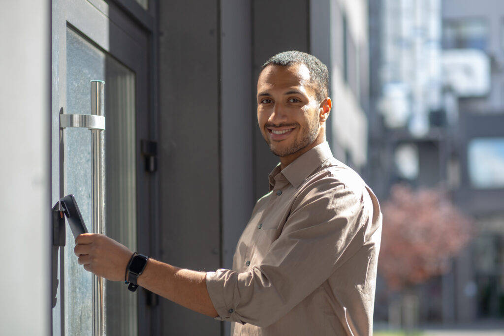 Businessman using access control card on commercial door